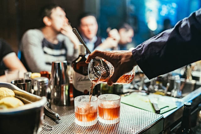 bartender pours cocktails